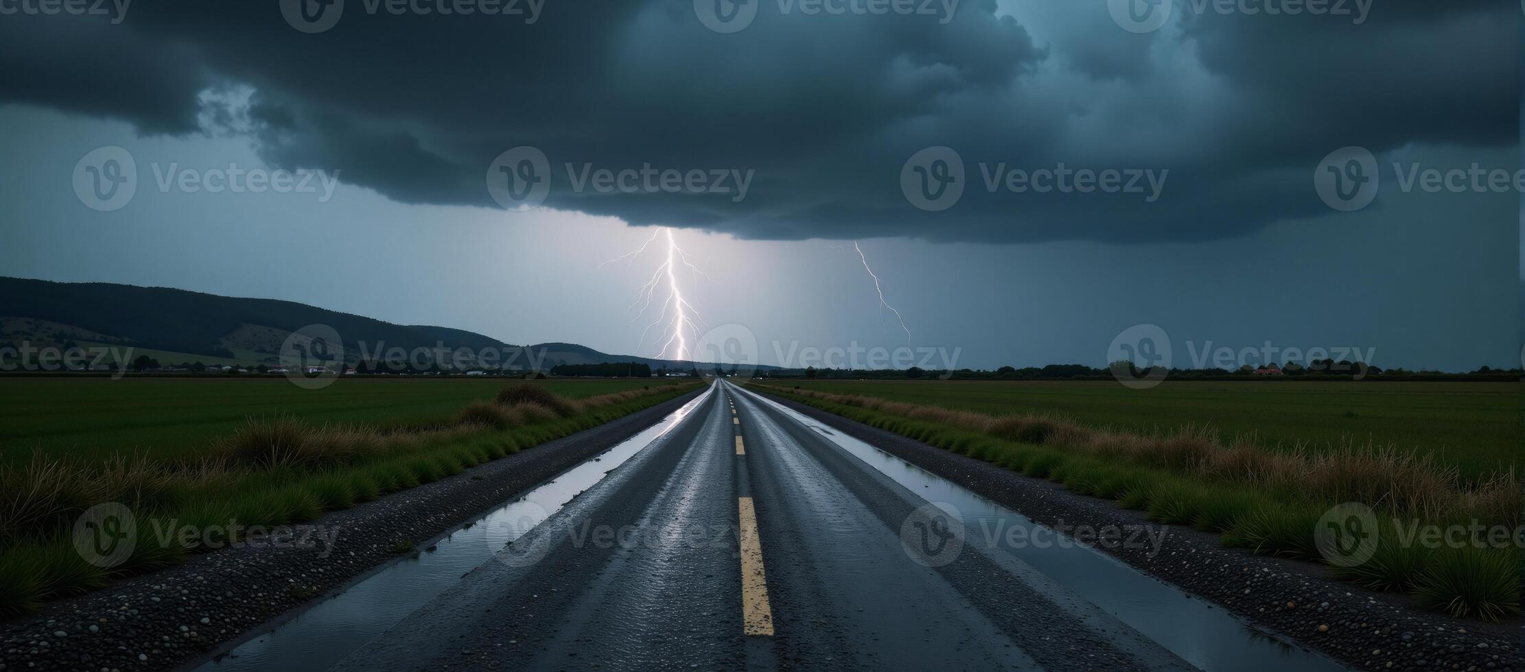 Stormtossed road with distant lightning and ominous clouds photo