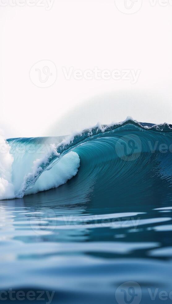 A closeup of an isolated blue ocean wave against a blank backdrop photo