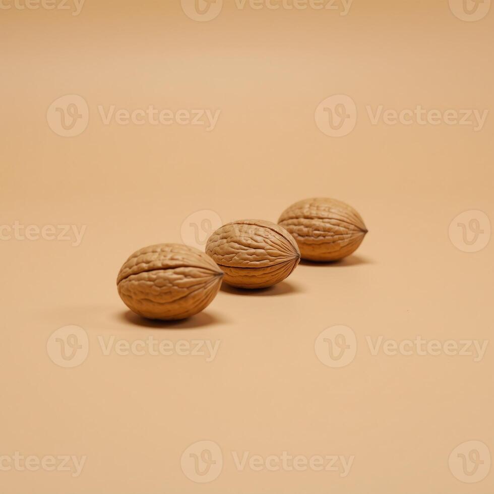 Three walnut shells against a beige backdrop photo