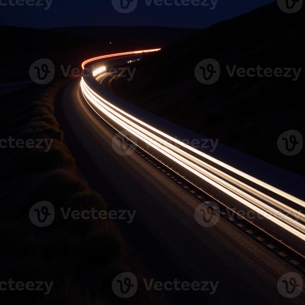 Fastmoving train trail lights across dark night road photo