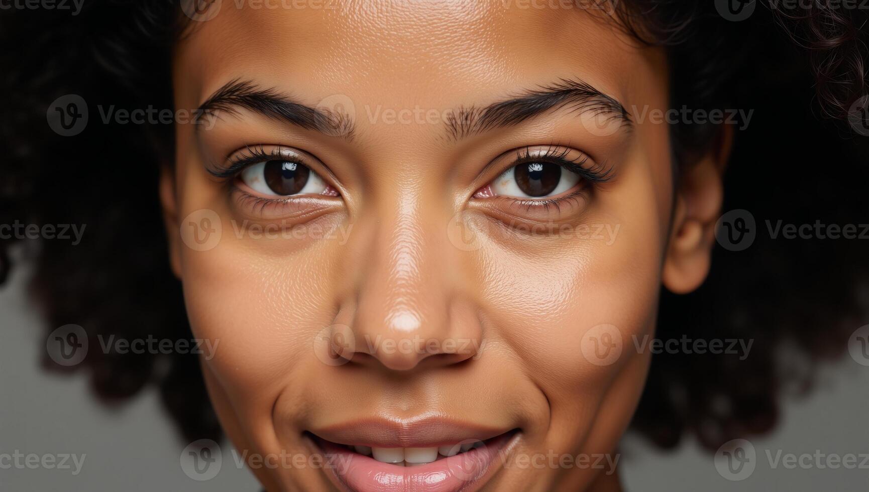 Portrait featuring a closeup view of a young beautiful African American woman looking directly into the camera photo