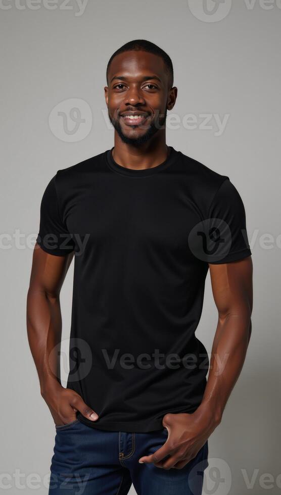 A confident AfricanAmerican model showcases the flexibility of a fitted black tee on a neutral backdrop photo