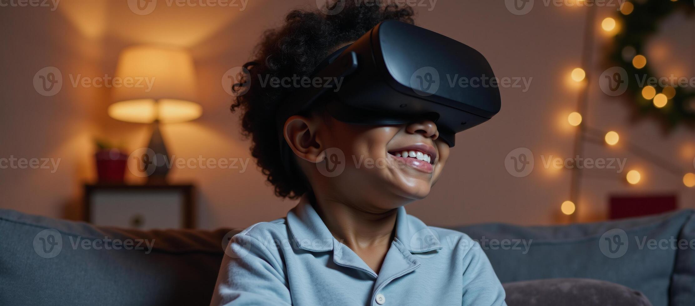 Cheerful AfricanAmerican child in pajamas using VR headset at Christmas time home setting photo