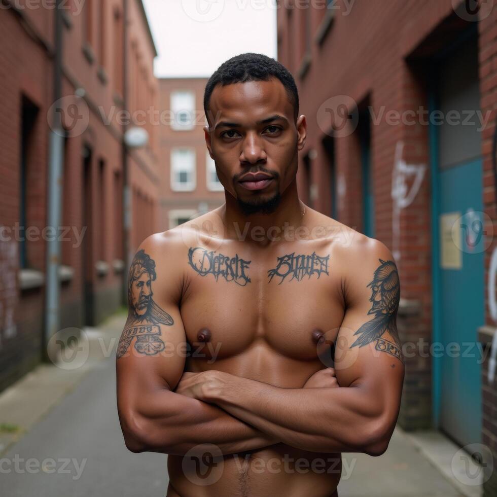 A confident tattooed streetwearclad black man stands proudly in a gritty urban setting radiating strength pride and unabashed uniqueness photo
