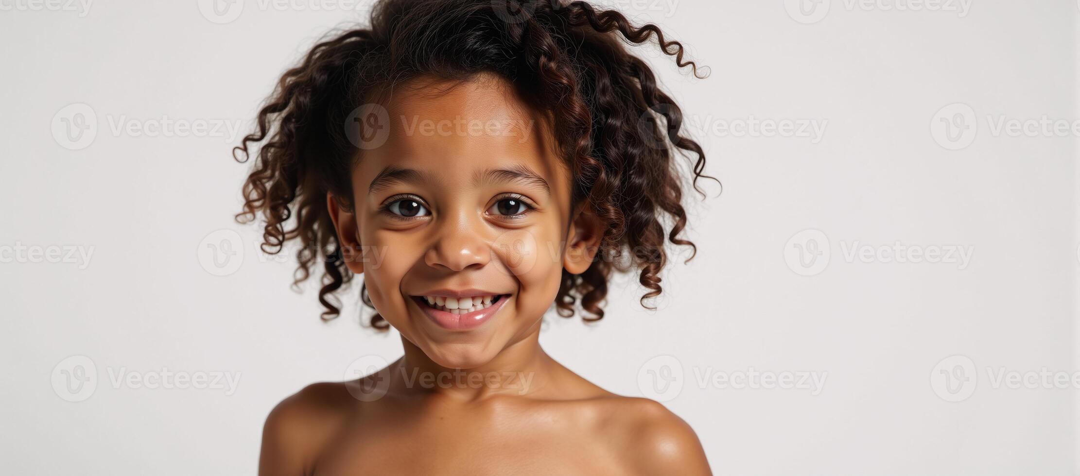 Adorable AfricanAmerican girl with curls and a splash on a clean white backdrop photo