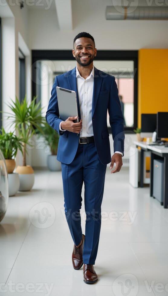 Cheerful African American male manager walking confidently through a colorful office space with tablet emanating positive energy photo