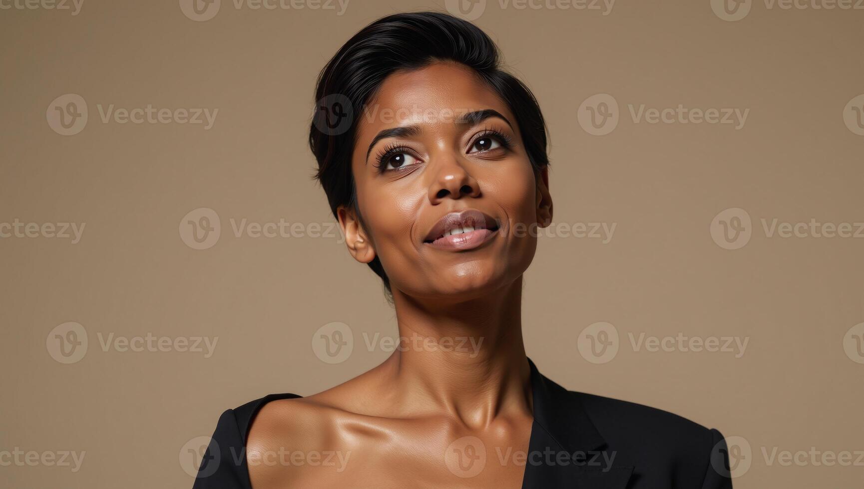 An Enchanting Portrait showcases a serene gaze from an African American woman looking upwards photo