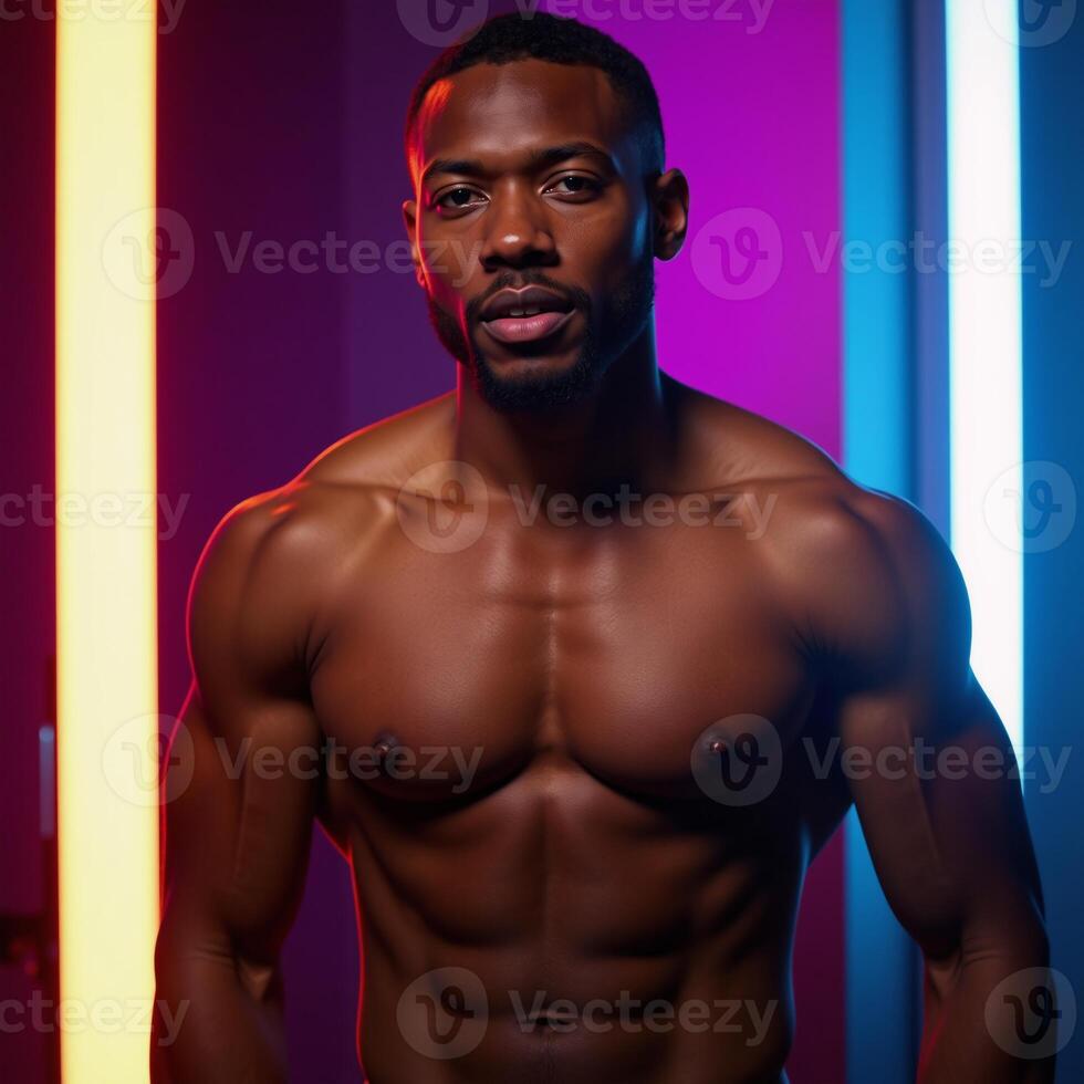 Black male portrait in neonlit studio with an emotive expression African American model photo
