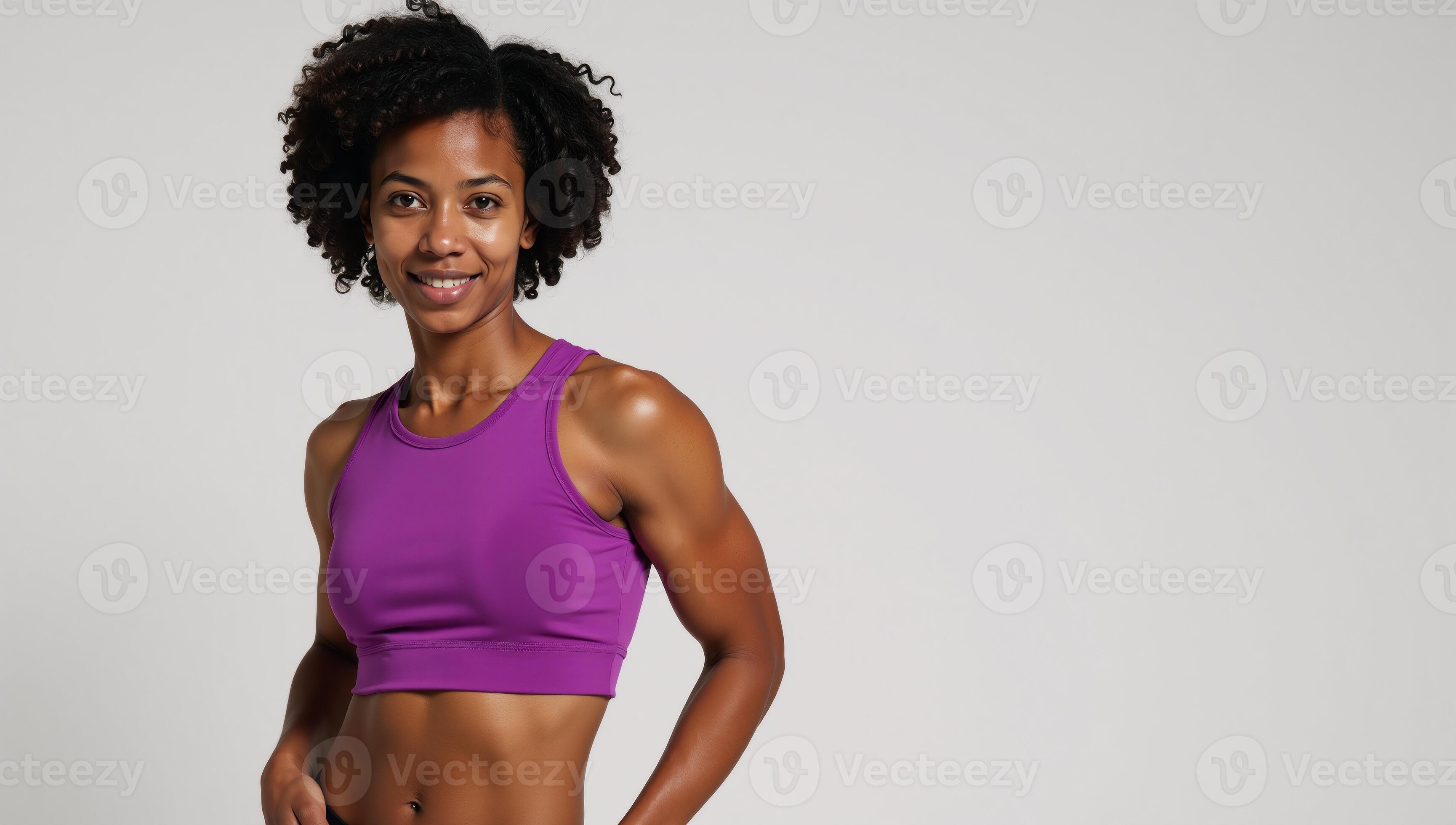 An African American fitness model showcases defined abs while wearing a