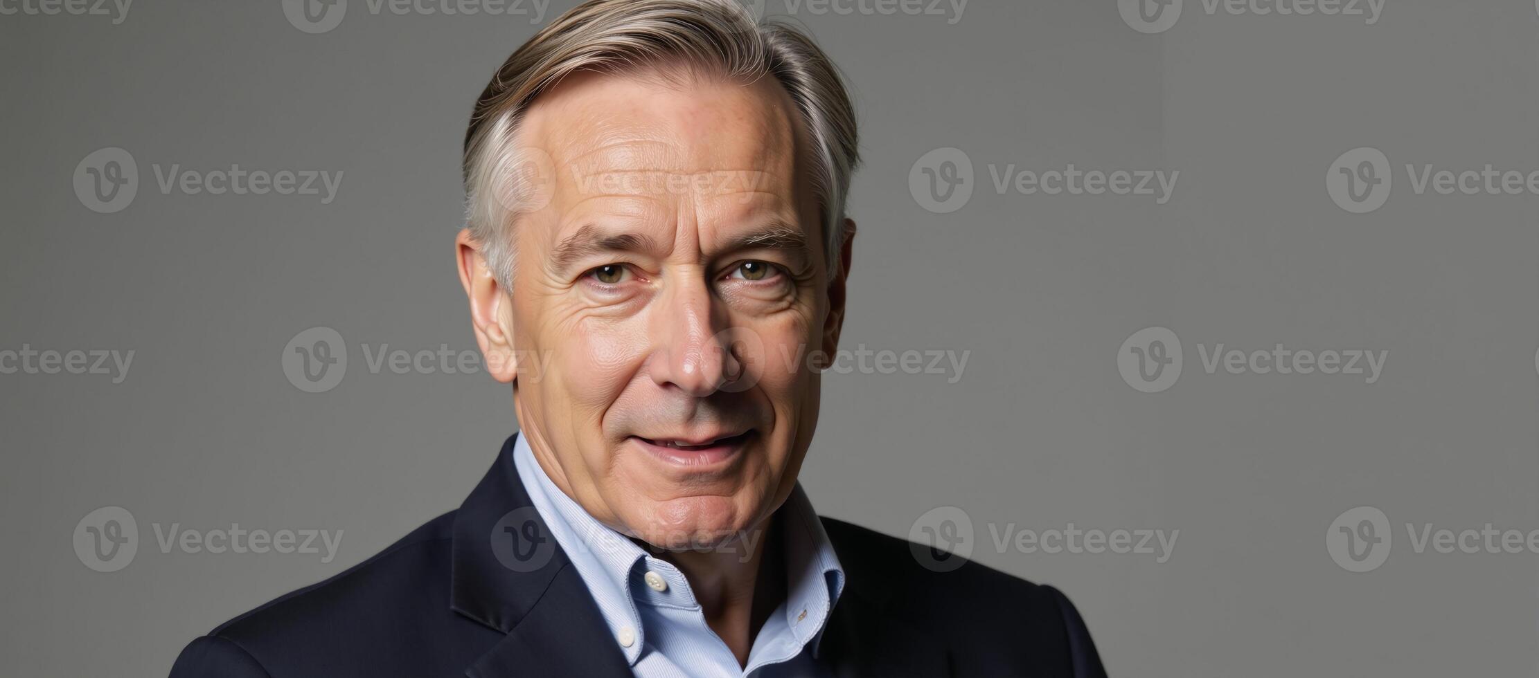 Senior gay man depicted against a simple gray backdrop in a portrait style image photo