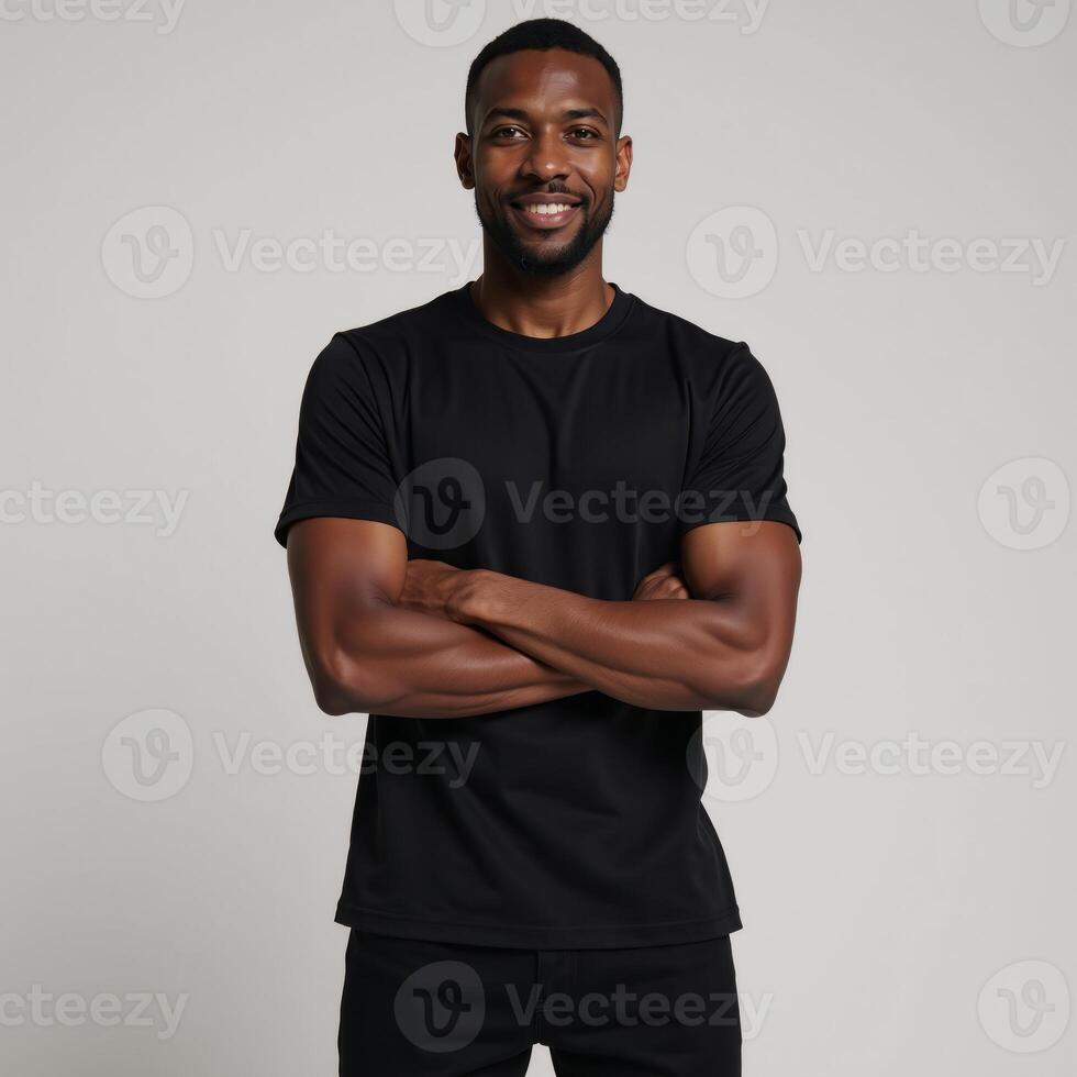 African American male model poses in a blank black tee perfect for logodesign placement on a neutral backdrop photo