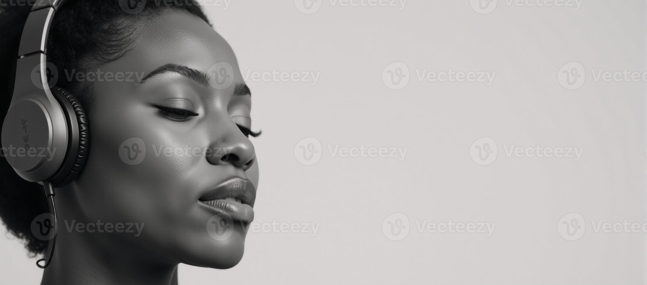 African American female closedeye portrait wearing headphones while listening to music photo
