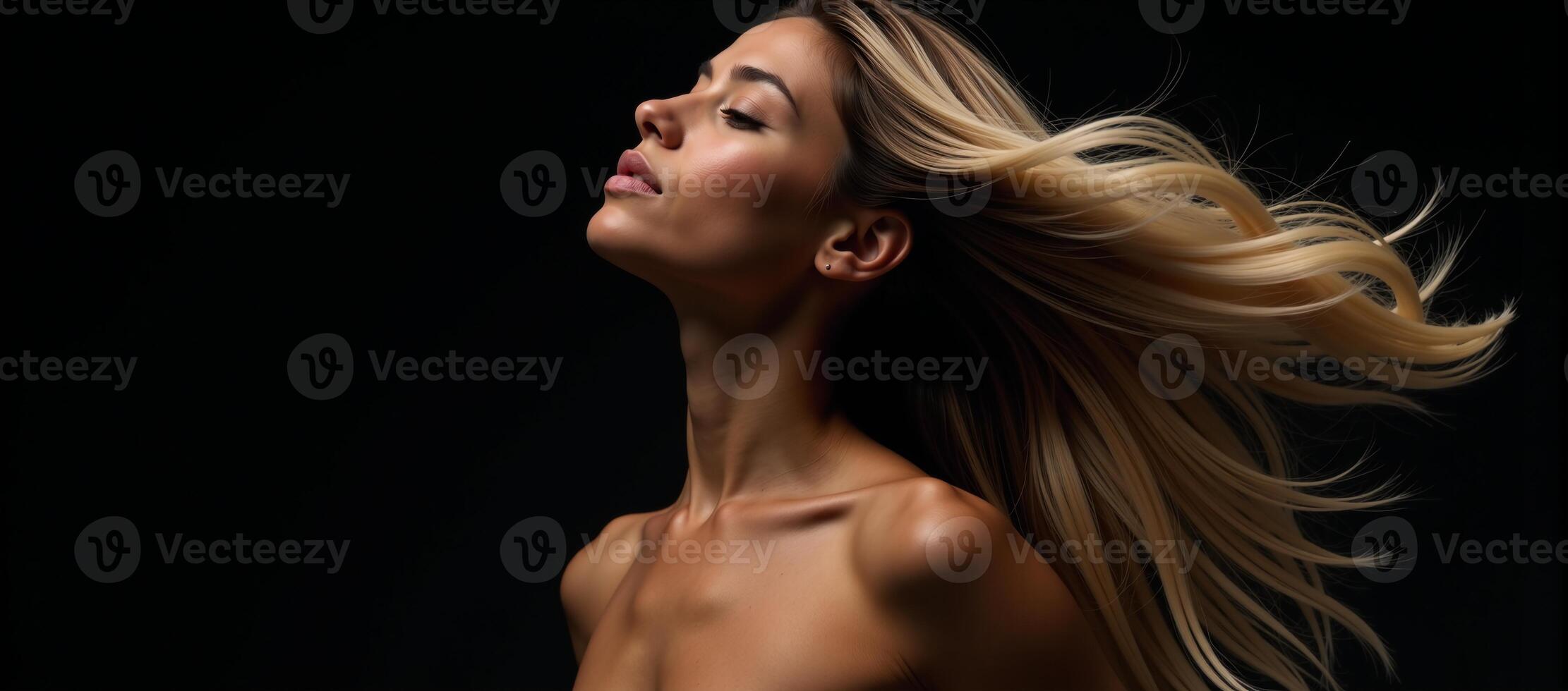 A stunning black woman with long blonde hair captured in motion against a black background photo