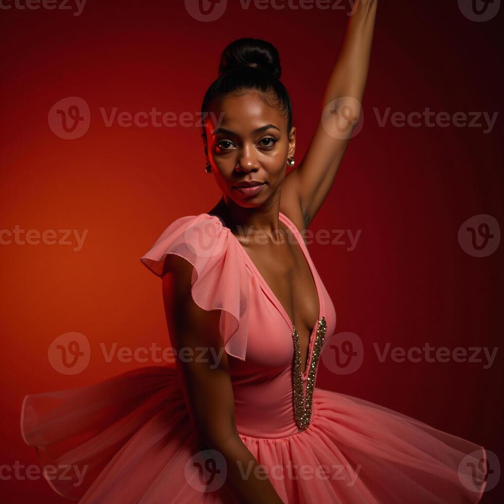 Painting featuring an African American ballerina posed against a vibrant red and orange backdrop photo
