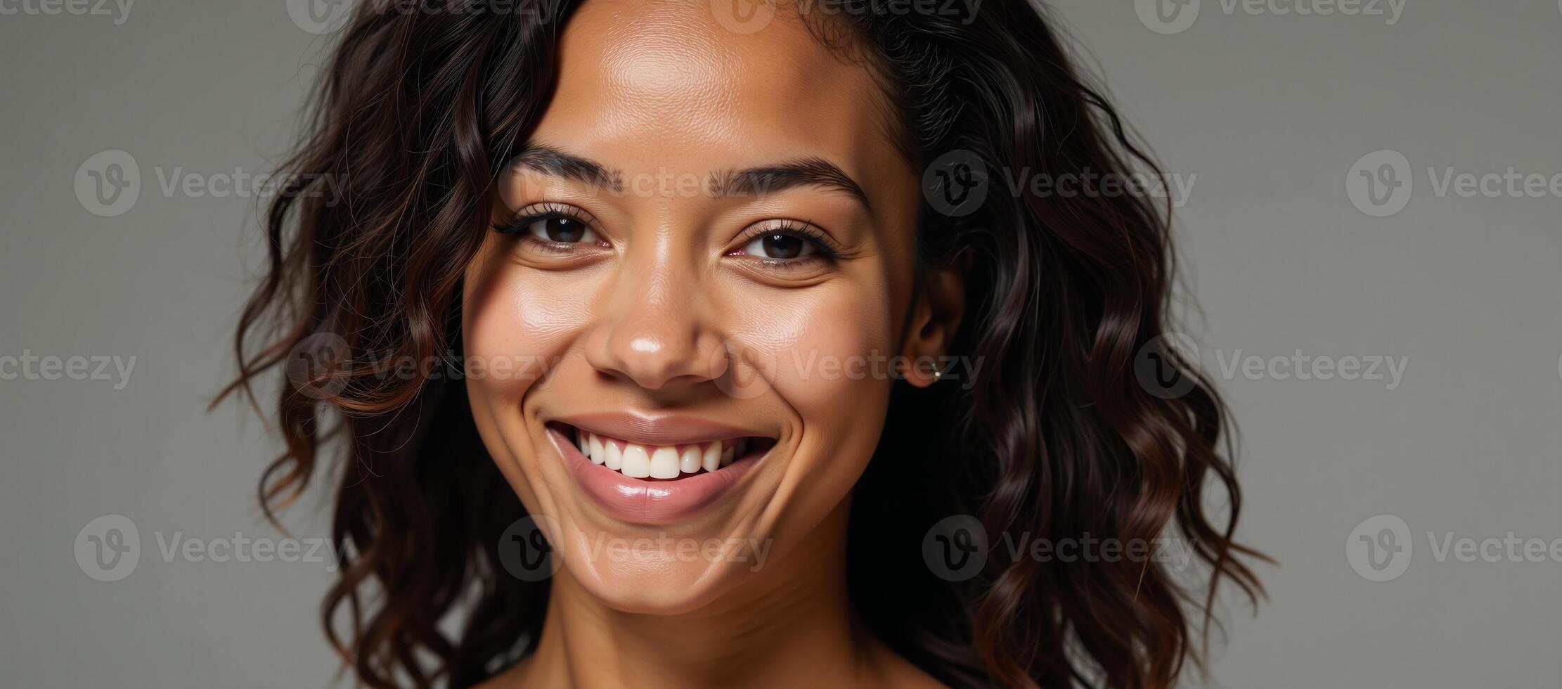A radiant African American woman with curls showcases gleaming skin and a joyful smile photo