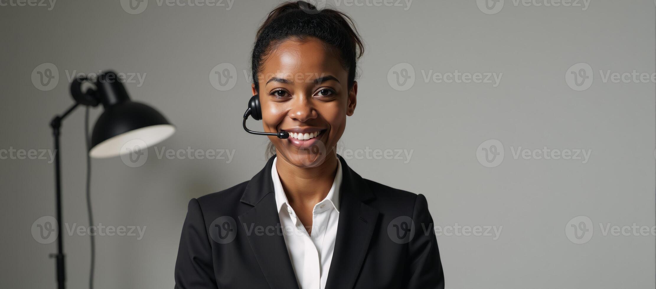 A focused African American woman at a call center with simple clean backdrop ideal for added textbranding photo