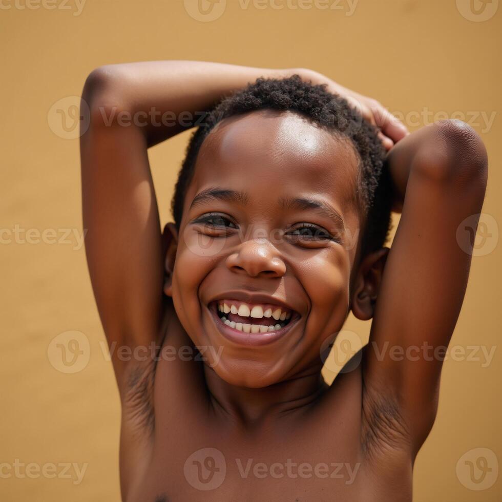 African American boy bursting with happiness grinning widely as he rises up from a seated position photo