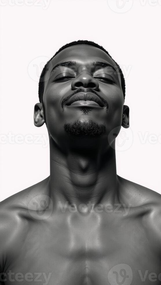 A blackandwhite double exposure portrait showcases a serene African American man sitting within a forest backdrop against a stark white background his closed eyes convey an air of contemplative peace photo