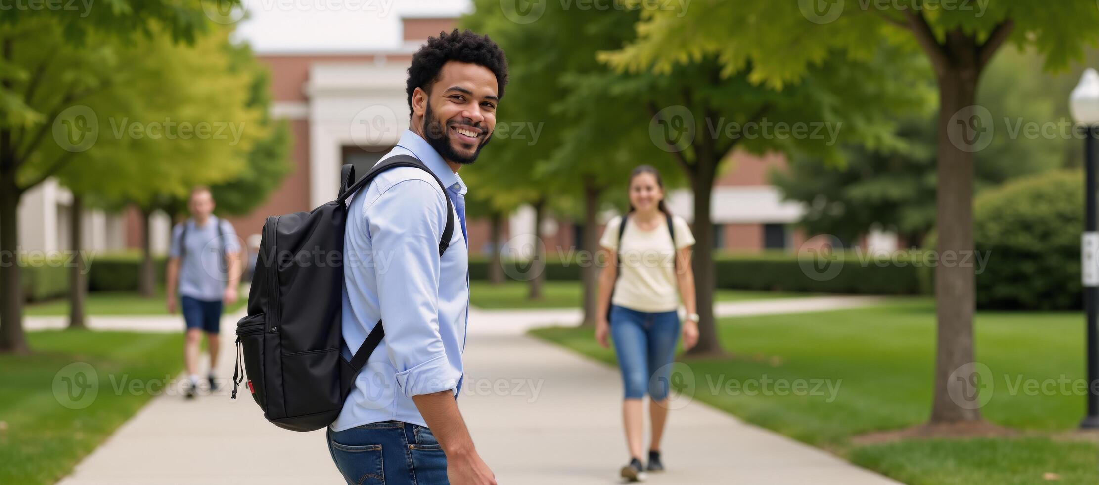 A confident AfricanAmerican college student strolls through campus with a smile donning casual attire and carrying his backpack photo