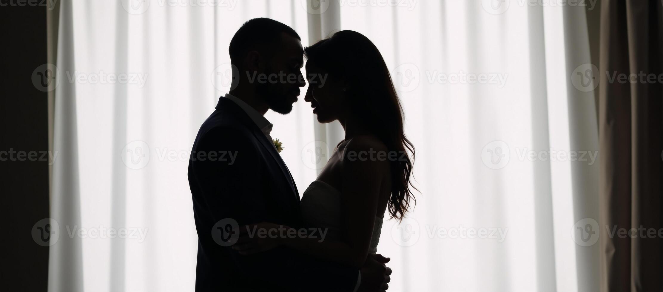 African American couple embracing silhouetted against empty backdrop with heart symbol and word love photo