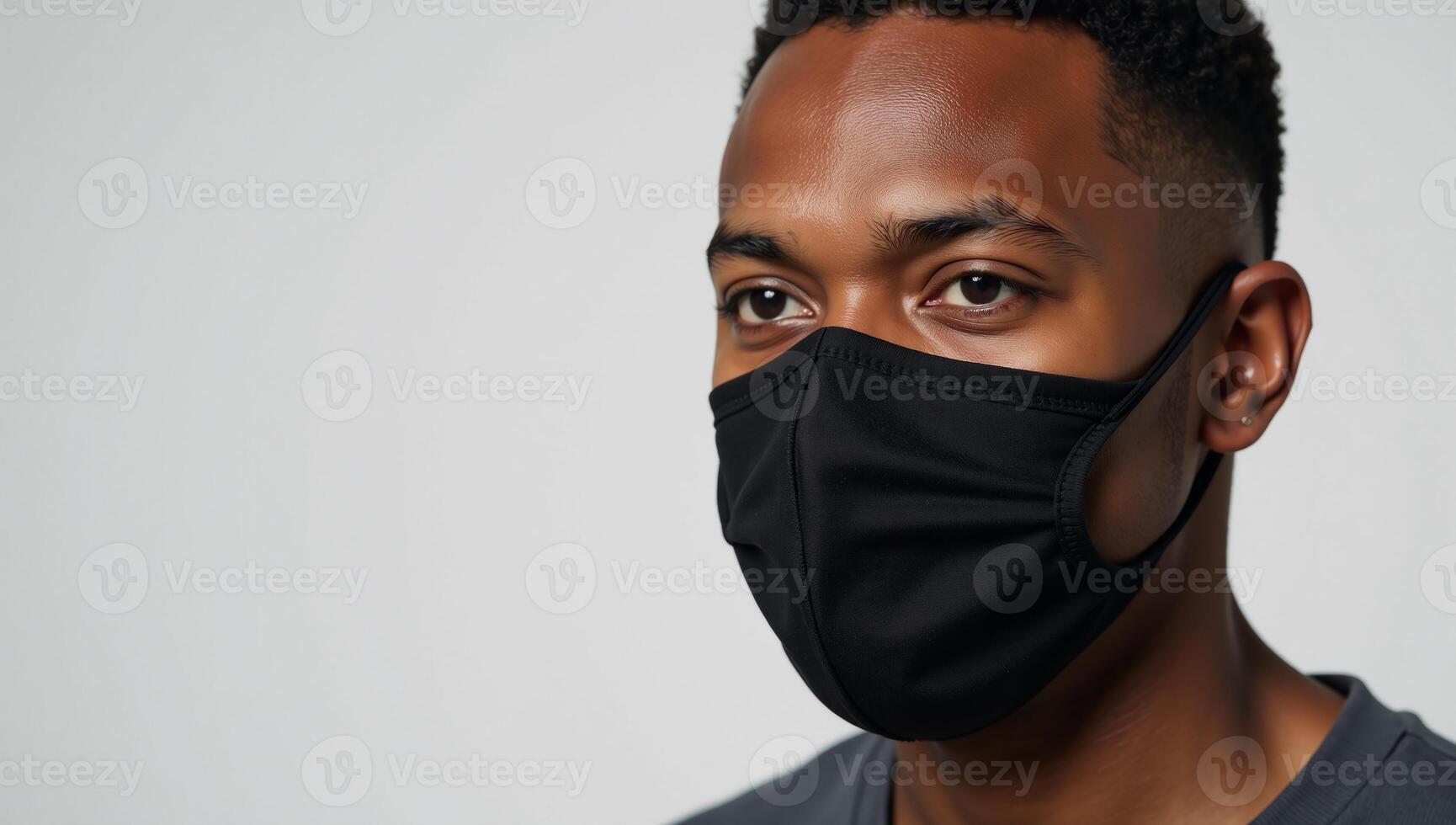 An AfricanAmerican man wearing a face mask due to COVID photo