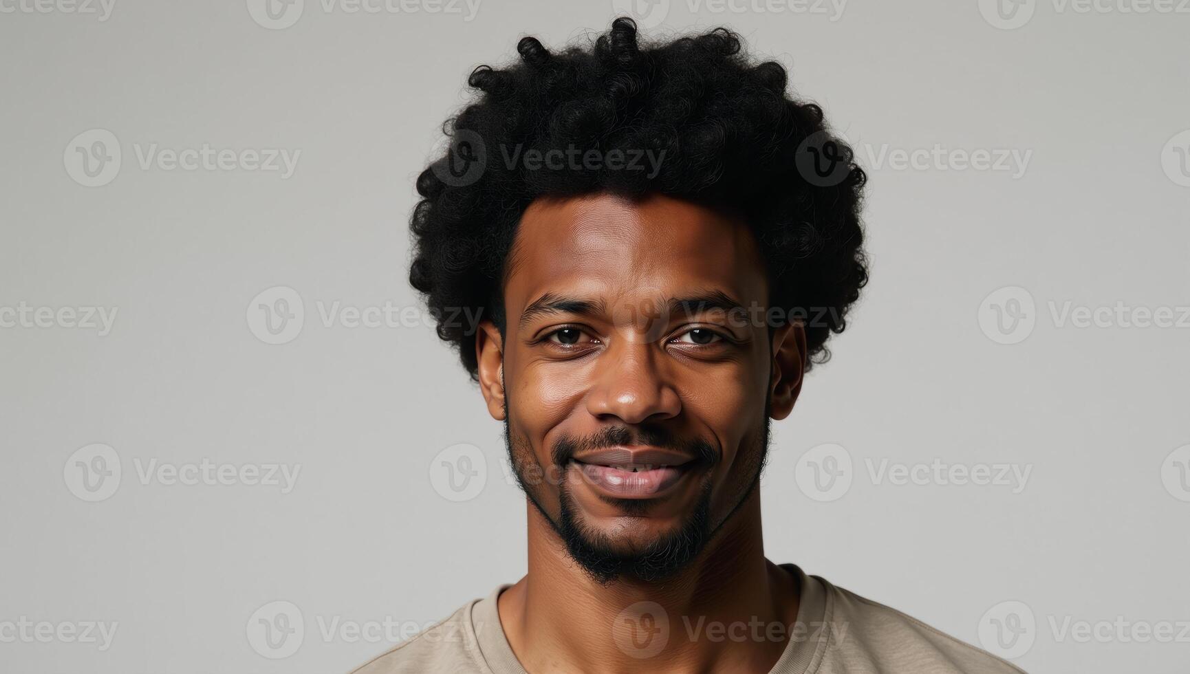 African American Man with Afro Hair stands alone against an empty backdrop photo