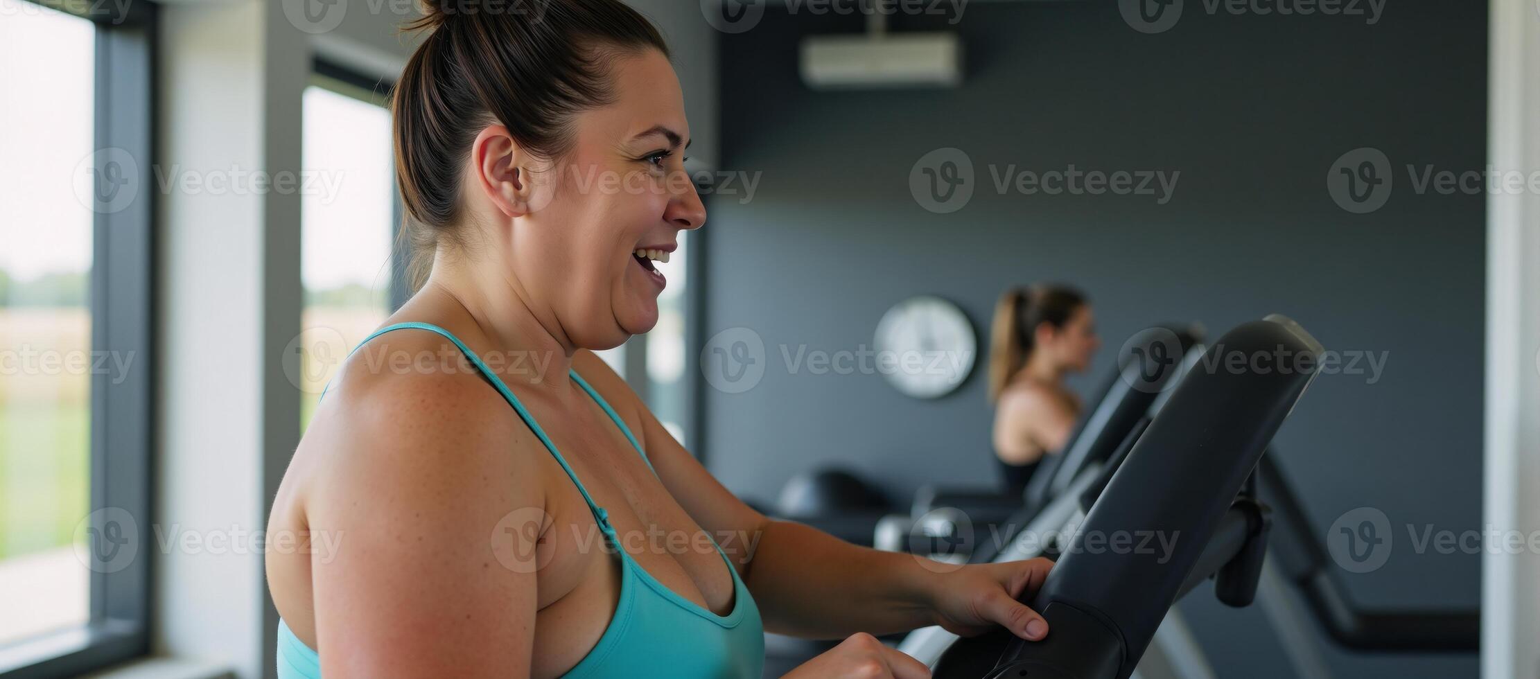 Obese woman exercises at the gym on a treadmill as symbolism for weight loss and a healthier lifestyle photo