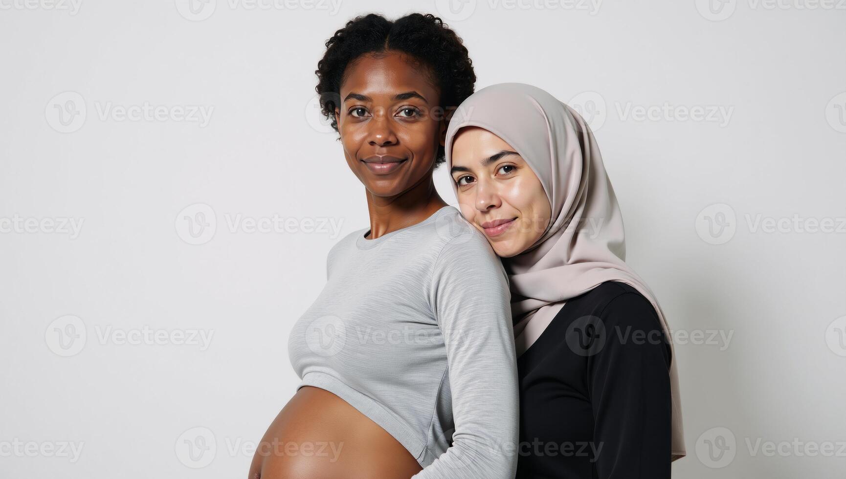 Young expectant AfricanAmerican woman in grey pullover faces Muslim obstetrician amidst white backdrop photo