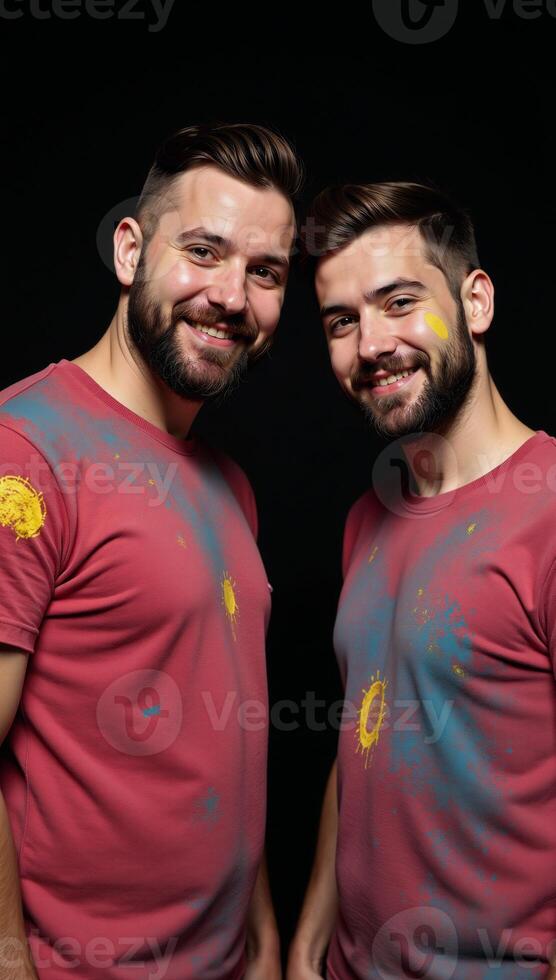 Black White portrait showcases a vibrant colorfully dressed gay couple posing playfully with paint on their faces against a stark black backdrop photo