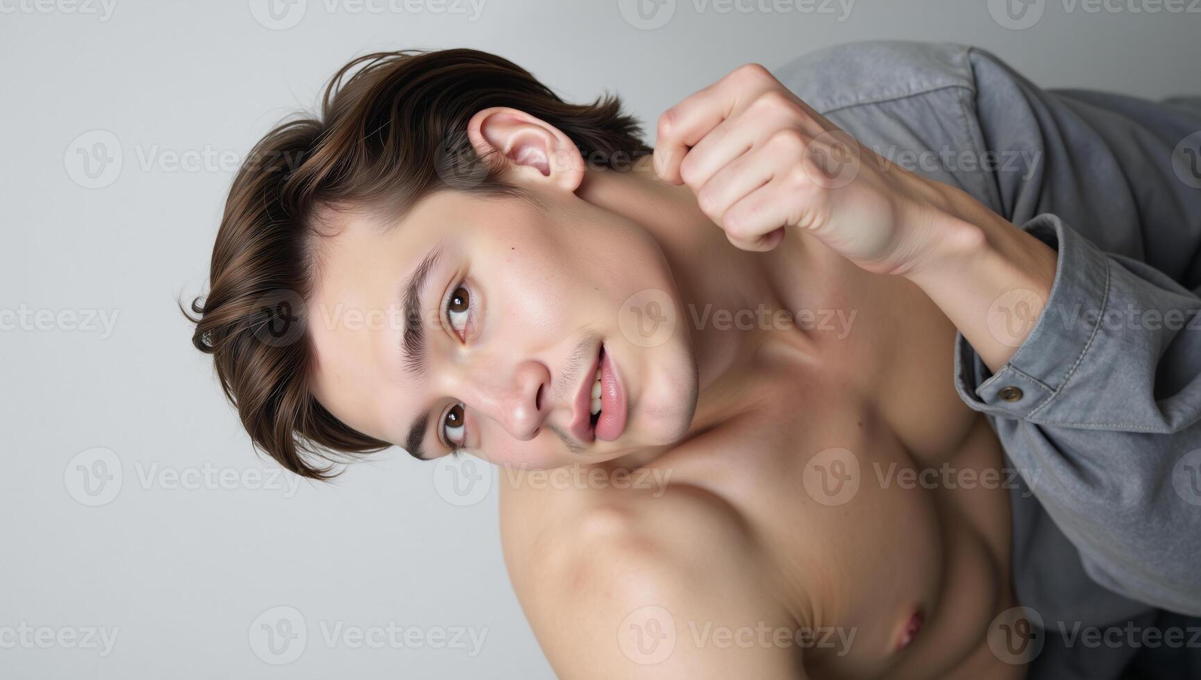 Portrait showcasing a stylish young openlygay individual against minimal background photo