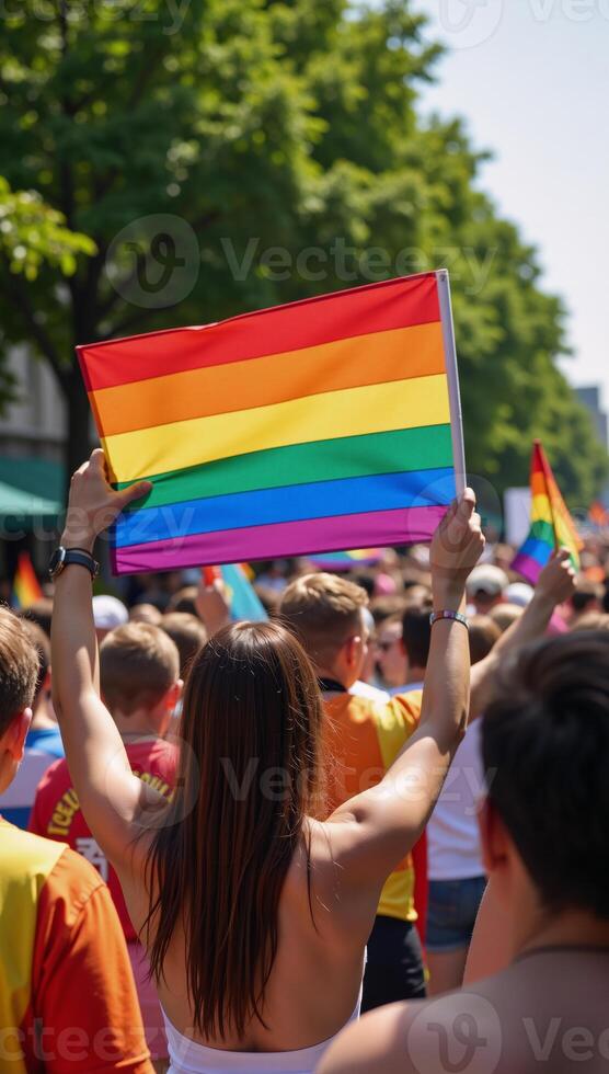 A vibrant and inclusive celebration of LGBTQ pride featuring an array of colorful individuals waving the rainbow flag at a diverse gradatedhued pride parade photo