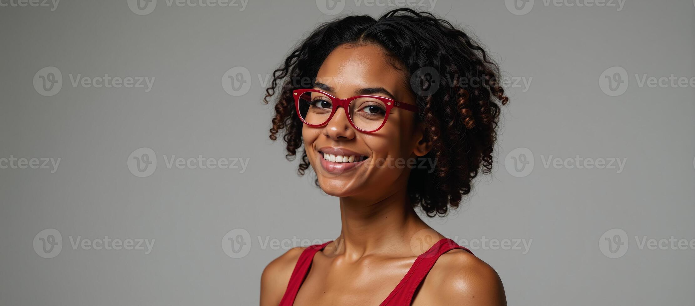 Portrait of a young fashionable African American woman wearing red glasses exuding confidence through her gaze photo
