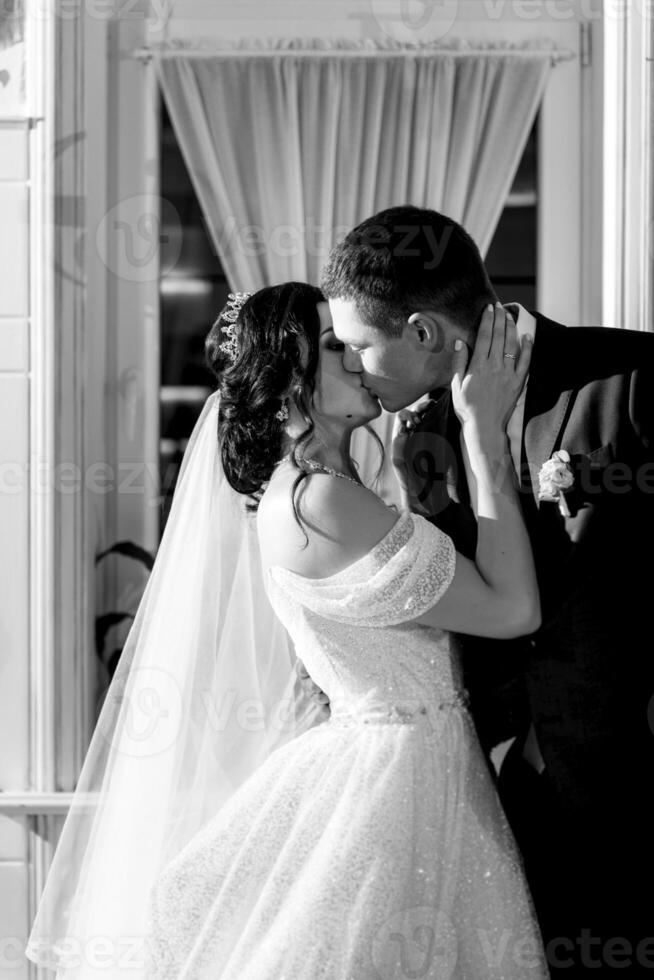 newlyweds happily cut and taste the wedding cake photo