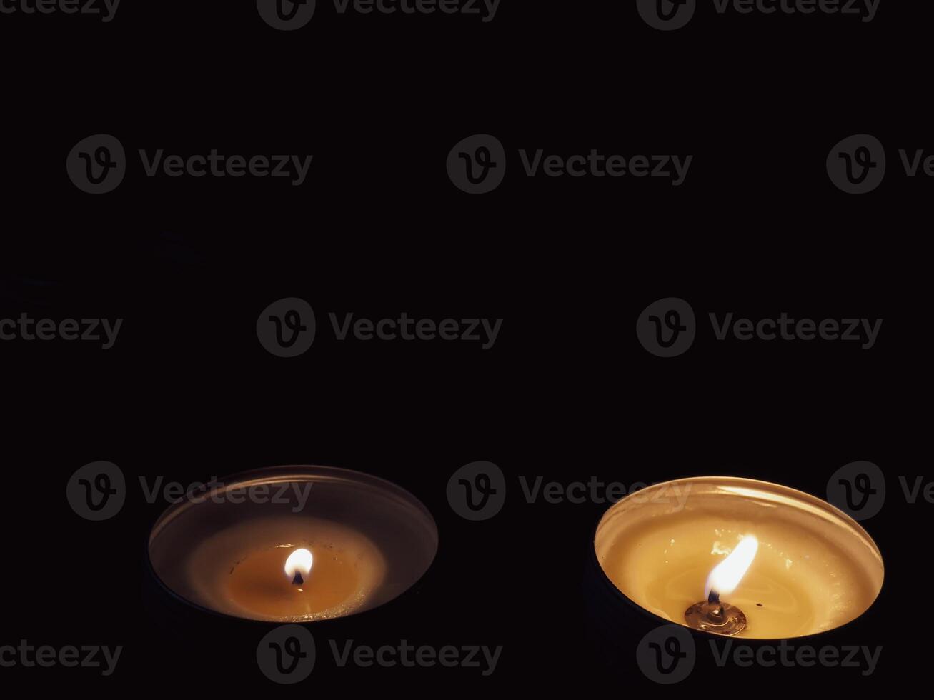 Scented candles in the dark at night for a spa or relaxation background. photo