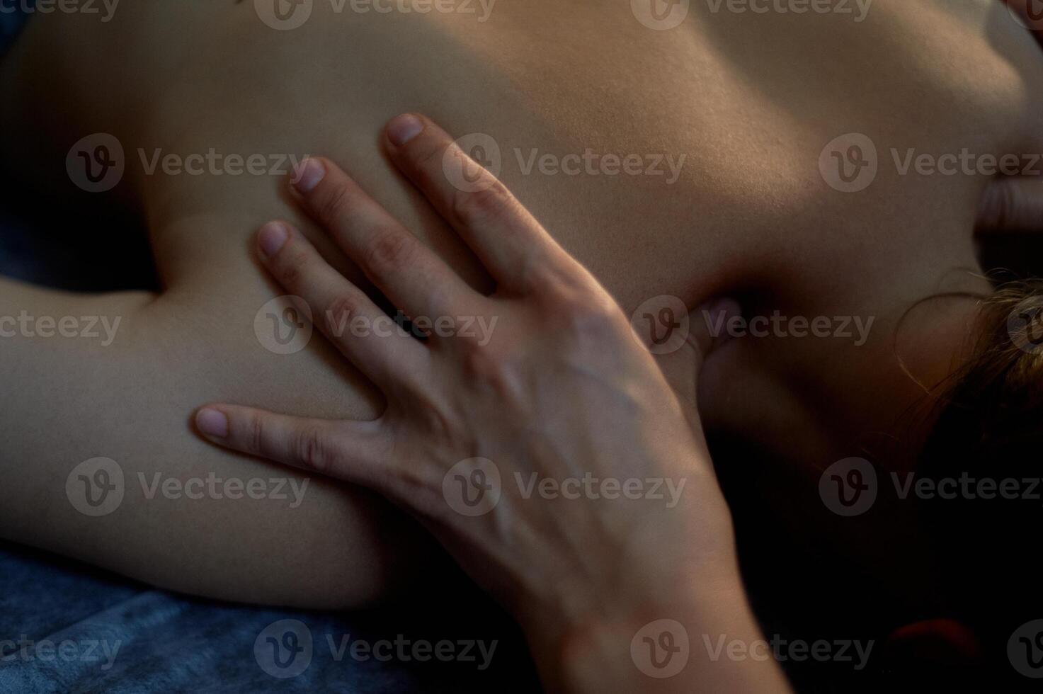 Massage of the cervical spine with great pressure on pain points. Relaxation of spasmodic muscles. photo
