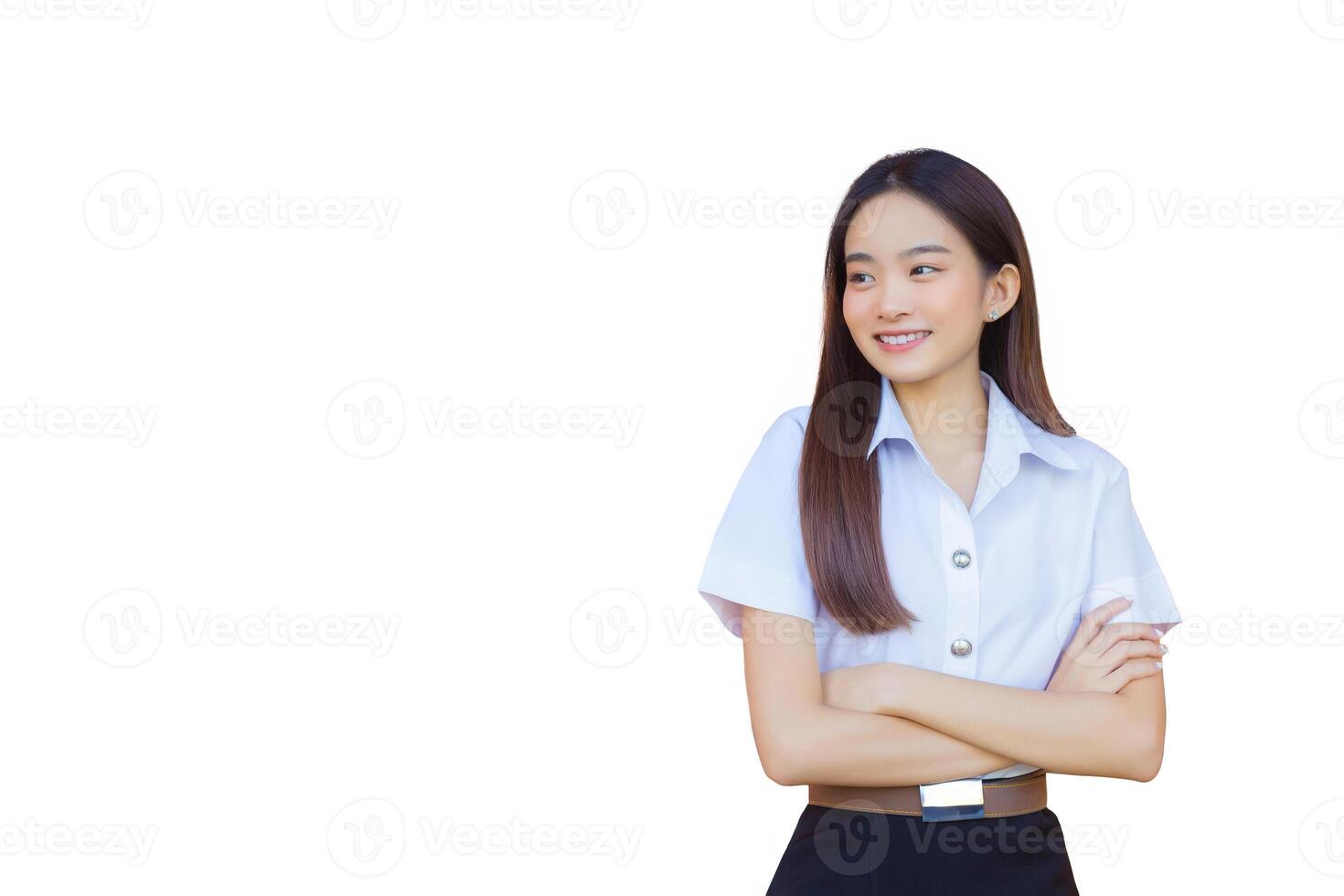 Portrait of an adult Thai student in university student uniform. Asian beautiful girl standing smiling happily and confidently with her arms crossed while isolated white background. photo