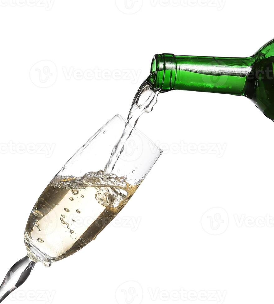 Champagne being poured into glass or flute, isolated on white photo