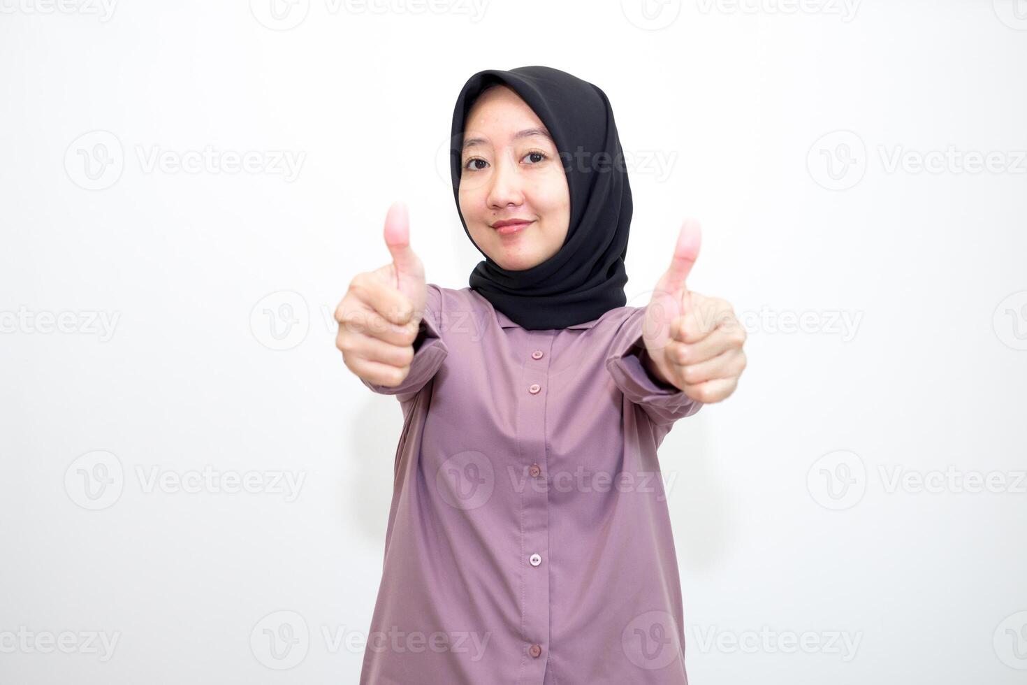 portrait of Indonesian Asian woman wearing shirt and hijab showing ok sign with one hand on eyes looking at camera through fingers. giving sign of agreement. Isolated on white Background photo