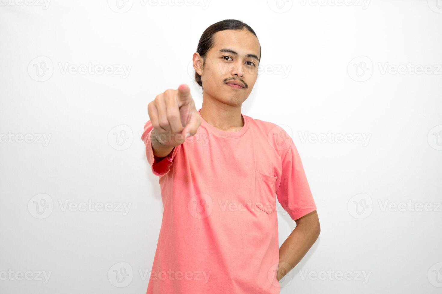 Asian, Indonesian man standing wearing pink shirt pointing right, left, up, down and presenting using hand gestures. Isolated on white background photo