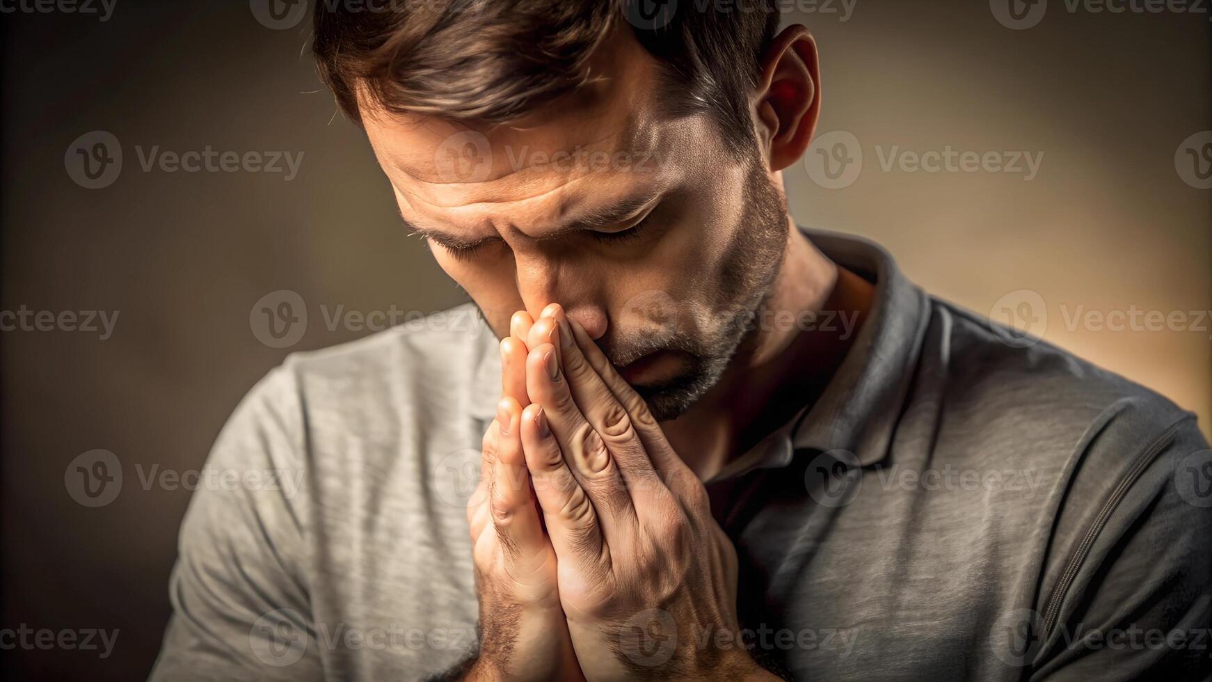 Thoughtful man with hands clasped in contemplation photo