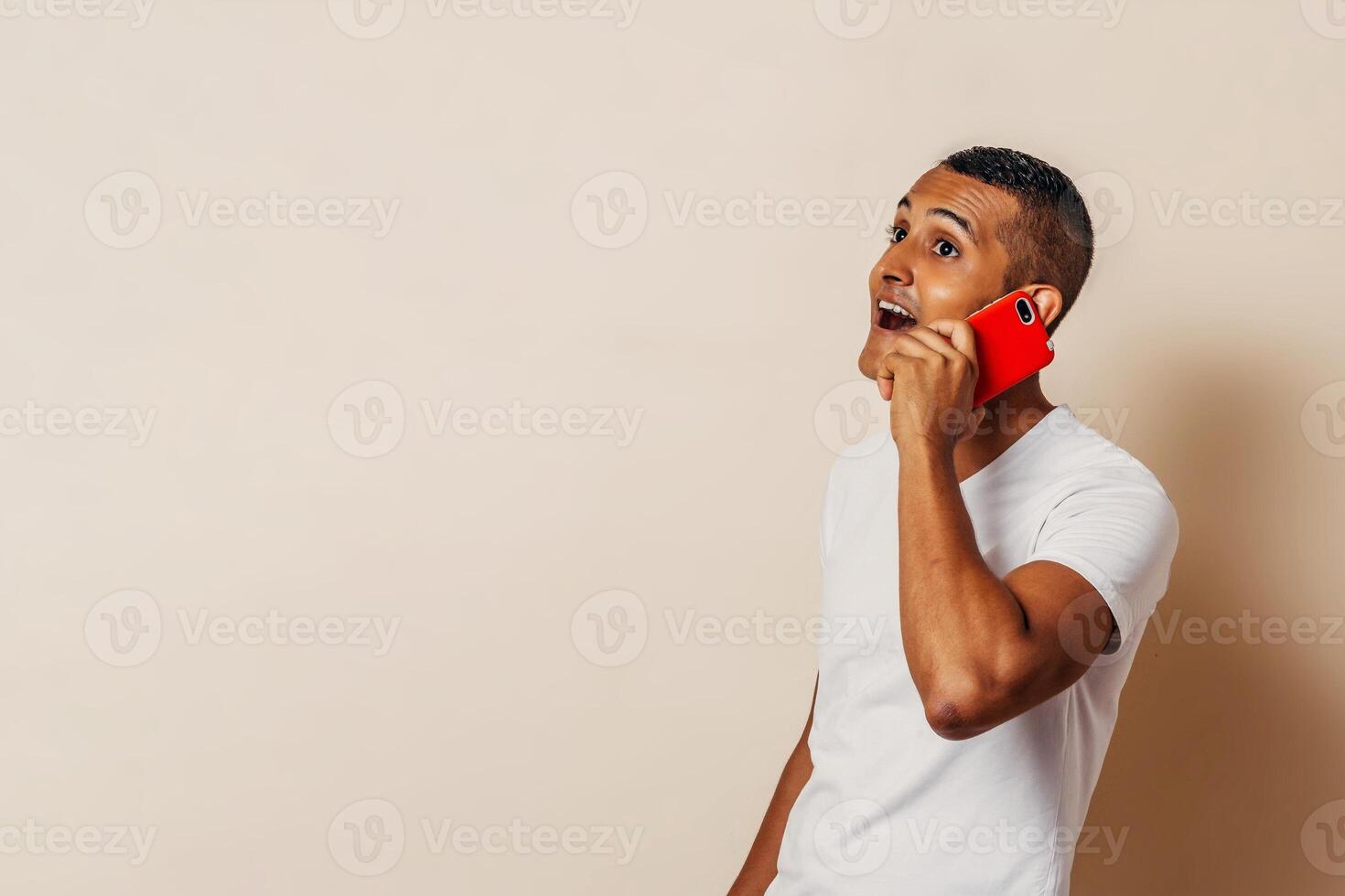 hispanic man taking a phone call. man using a smartphone. photo