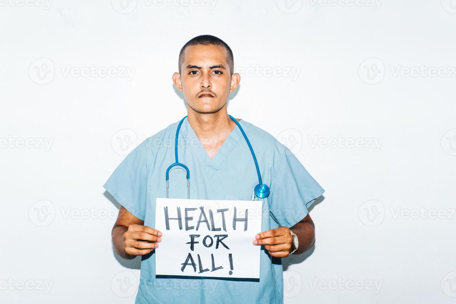 portrait of a male doctor with a banner that reads health for all. concept health crisis, hospitals and infections. photo