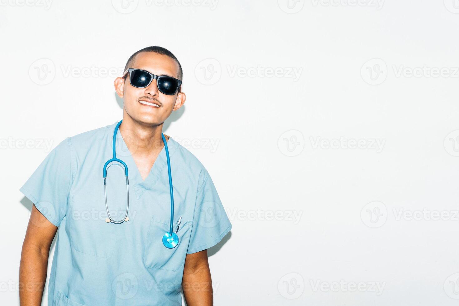 man dressed as doctor with summer sunglasses, smiling and cheerful. summer concept. photo