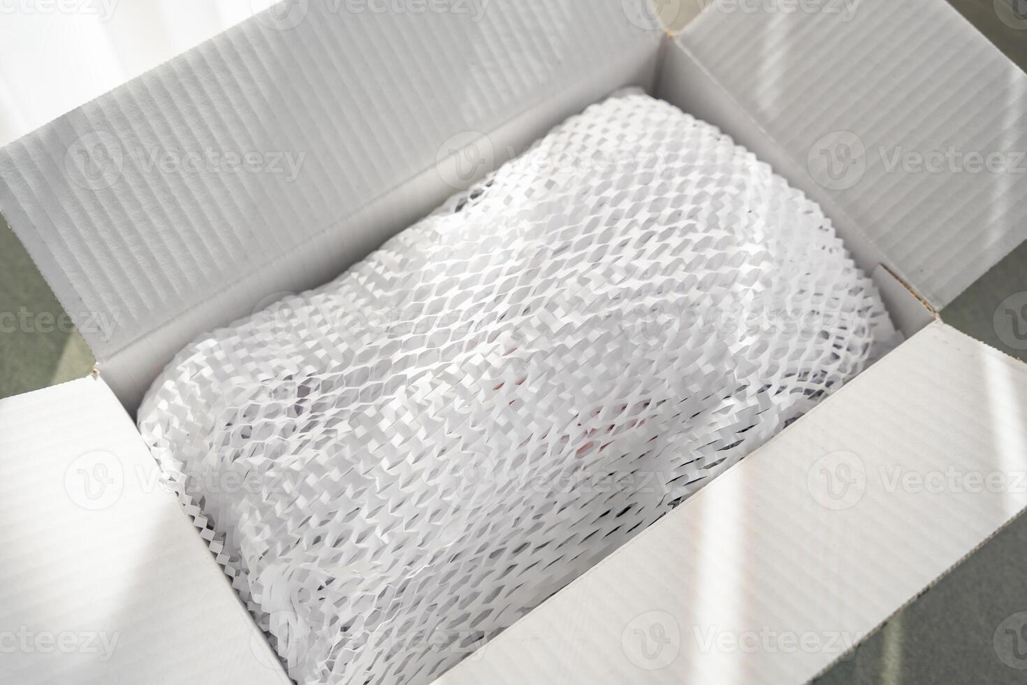 Corrugated white paper for safe transportation, in which the goods brought by the courier delivery service are wrapped, environmental packaging concept. High quality photo
