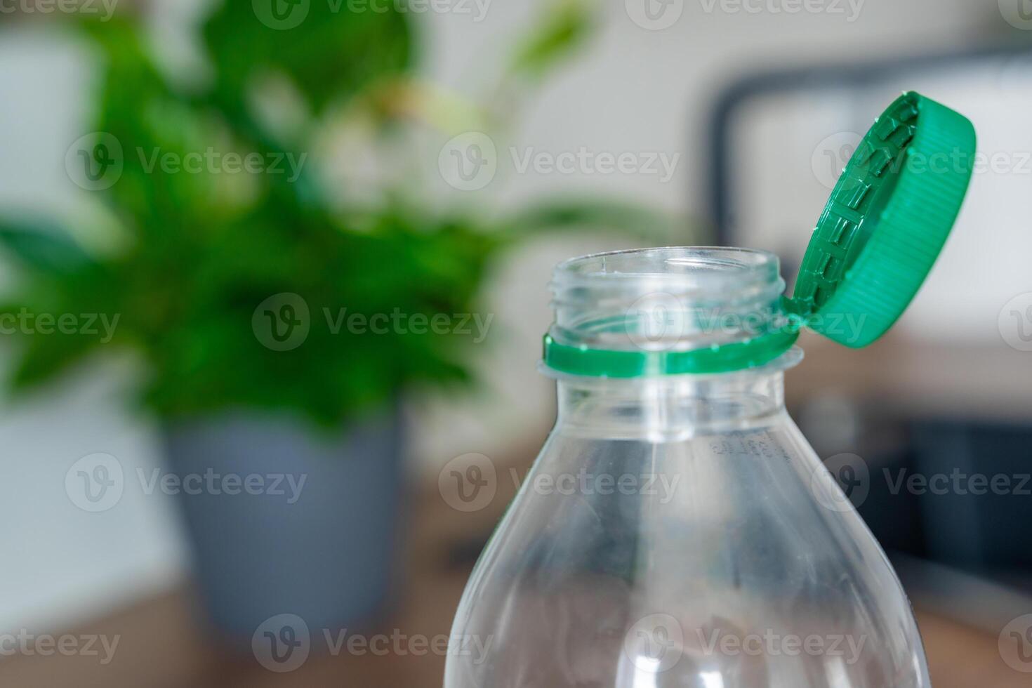Stationary plastic cap on a PET bottle. The new design means the cap remains attached to the bottle after opening, making the entire package easier to collect and recycle. High quality photo