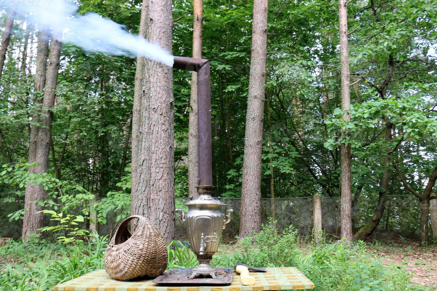 smoke is coming out of the samovar's chimney photo