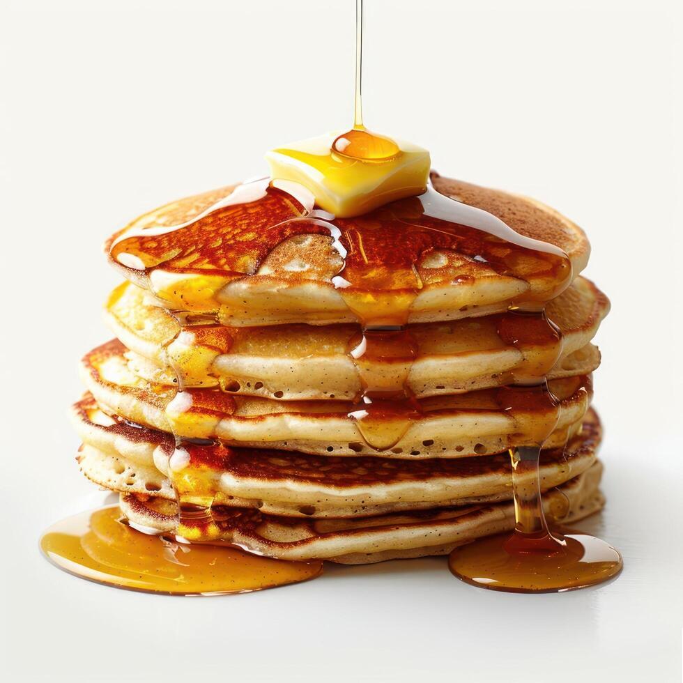 a stack of pancakes covered in syrup and butter photo