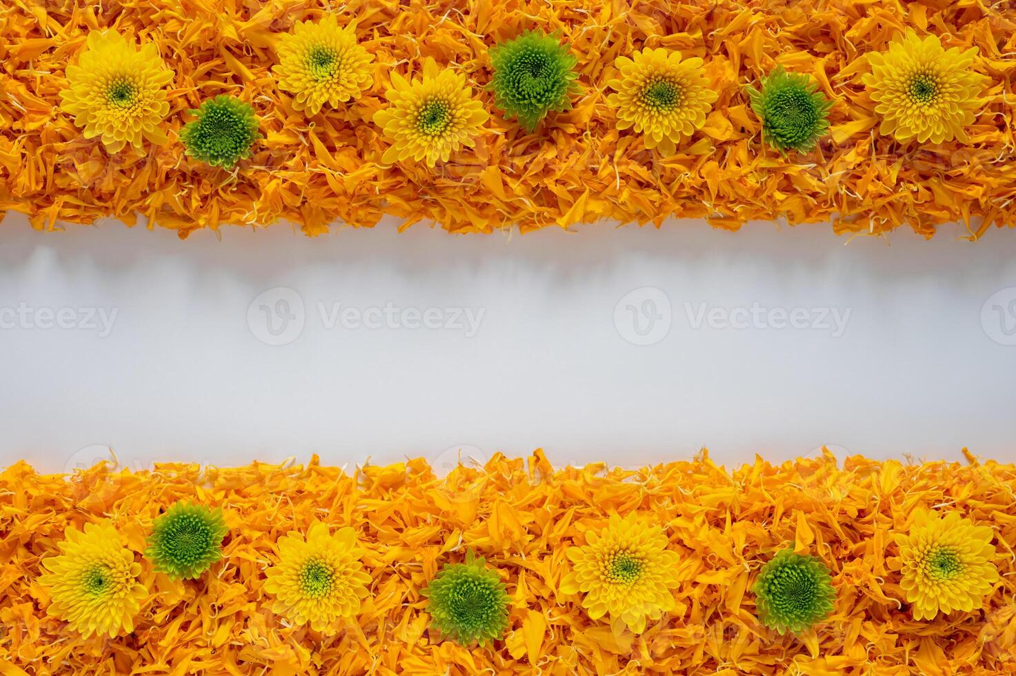 Decorative orange color marigold flower petals rangoli with Chrysanthemum flowers for Diwali festival with white space background. photo