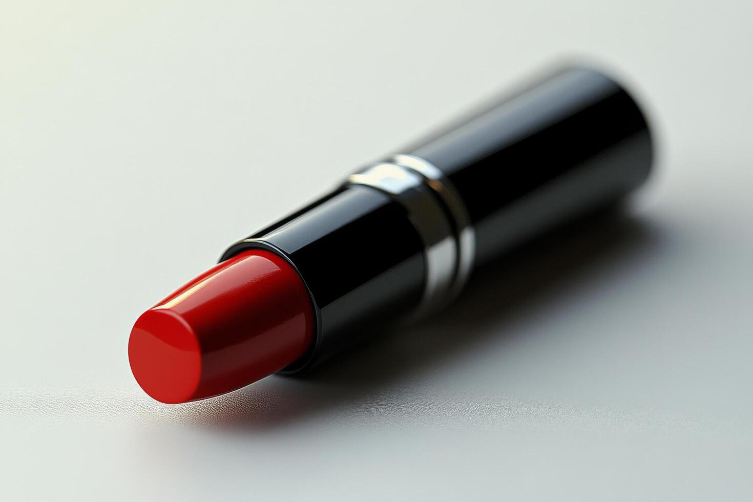 Bright red lipstick tube placed on a light surface with a minimalist design in a stylish setting photo