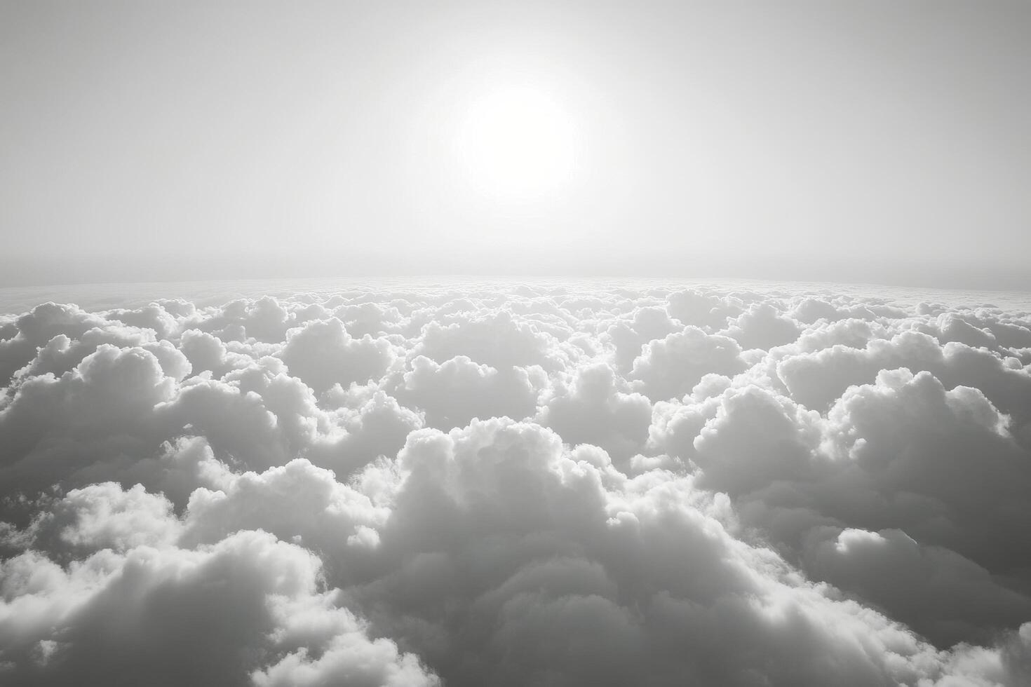 Sunrise over a sea of clouds showcasing dramatic light and shadow in black and white photo